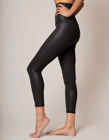 Black leggings worn by a person on a plain background