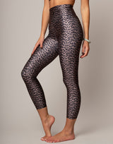 Person wearing leopard print leggings on a plain background