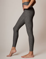 Person wearing gray leggings on a plain background