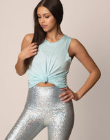 woman wearing light blue colored tank on grey background