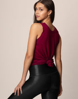 woman wearing tank top in merlot on grey background