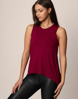 woman wearing tank top in merlot on grey background