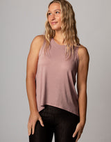 woman wearing pale mauve colored tank on grey background