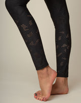 woman wearing chic woven star printed legging on grey background