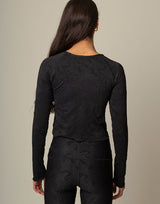 woman wearing long sleeve chic woven star printed sports top on grey background