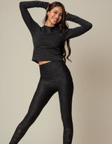 woman wearing long sleeve chic woven star printed sports top on grey background