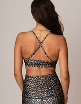 woman wearing leopard print sports bra against grey background