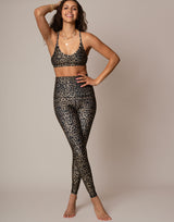 woman wearing leopard printed legging on grey background