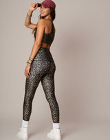 woman wearing leopard printed sports crop on grey background