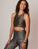 woman wearing leopard printed sports crop on grey background