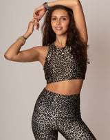 woman wearing leopard printed sports crop on grey background