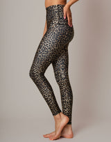 woman wearing leopard printed legging on grey background