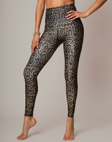 woman wearing leopard printed legging on grey background