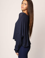 woman wearing oversized waffle knit long sleeve top in navy on grey background