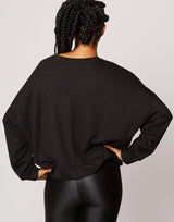 woman wearing pullover sweater in black on grey background