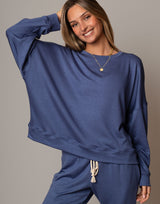 Woman wearing a blue outfit with a plain background