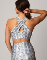 woman wearing white python printed sports crop on grey background