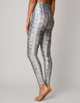 woman wearing white python printed legging on grey background