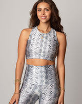 woman wearing white python printed sports crop on grey background