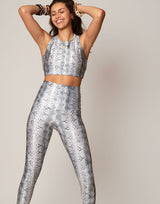 woman wearing white python printed sports crop on grey background