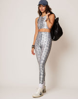 woman wearing white python printed legging on grey background