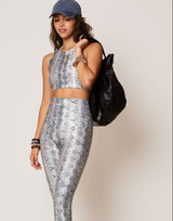 woman wearing white python printed legging on grey background