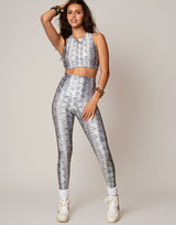woman wearing white python printed sports crop on grey background