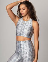 woman wearing white python printed sports crop on grey background