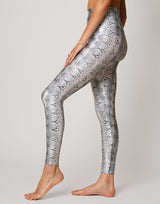 woman wearing white python printed legging on grey background