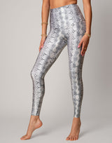 woman wearing white python printed legging on grey background