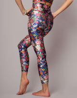 Colorful floral leggings worn by a person on a gray background
