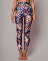 Colorful floral leggings worn by a person on a plain background