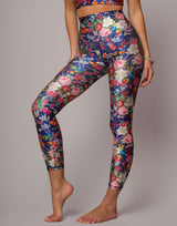 Floral leggings worn by a person on a gray background