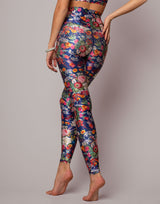 Multicolored floral leggings worn by a person on a plain background