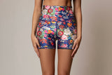Floral patterned shorts worn by a person on a plain background