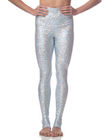 woman wearing long legging with mermaid pattern of crystal blue colored sparkling fish scales on grey background