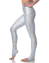 woman wearing long legging with mermaid pattern of crystal blue colored sparkling fish scales on grey background