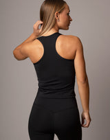 woman wearing tank top in black on grey background