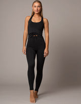 woman wearing legging in black on grey background