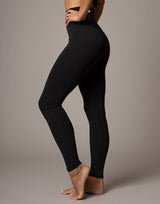 woman wearing legging in black on grey background