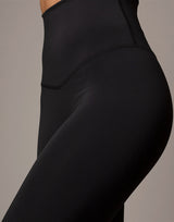 woman wearing legging in black on grey background