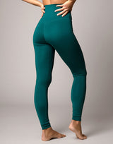 woman wearing legging in forest green on grey background