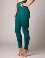 woman wearing legging in forest green on grey background