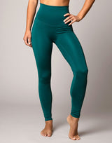 woman wearing legging in forest green on grey background