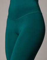 woman wearing legging in forest green on grey background