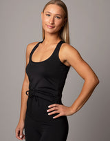 woman wearing tank top in black on grey background
