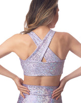 woman wearing crop top with mermaid pattern of lavender purple colored sparkling fish scales on grey background