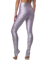 woman wearing long legging with mermaid pattern of lavender purple colored sparkling fish scales on grey background