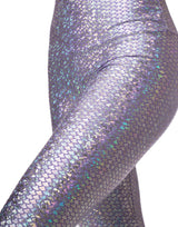 woman wearing long legging with mermaid pattern of lavender purple colored sparkling fish scales on grey background