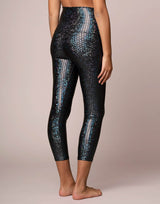 woman wearing legging with mermaid pattern of midnight black colored sparkling fish scales